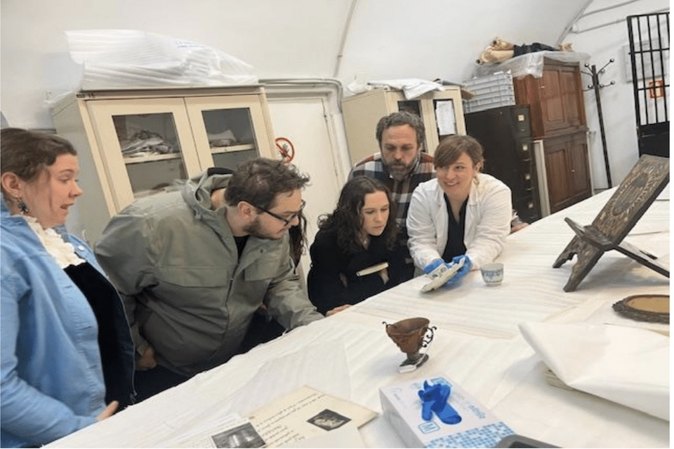 Students study a manuscript in the SLU Madrid library archives.