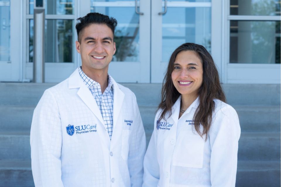 Mohs Faculty Two faculty members pose outdoors.