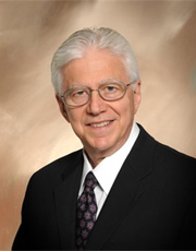 Headshot of Henry Kaplan, wearing black suit jacket Headshot of Henry Kaplan