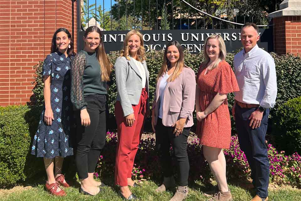 Group photo of adult neuropsychology fellows standing in front of medical center sign Group photo of adult neuropsychology fellows standing in front of medical center sign
