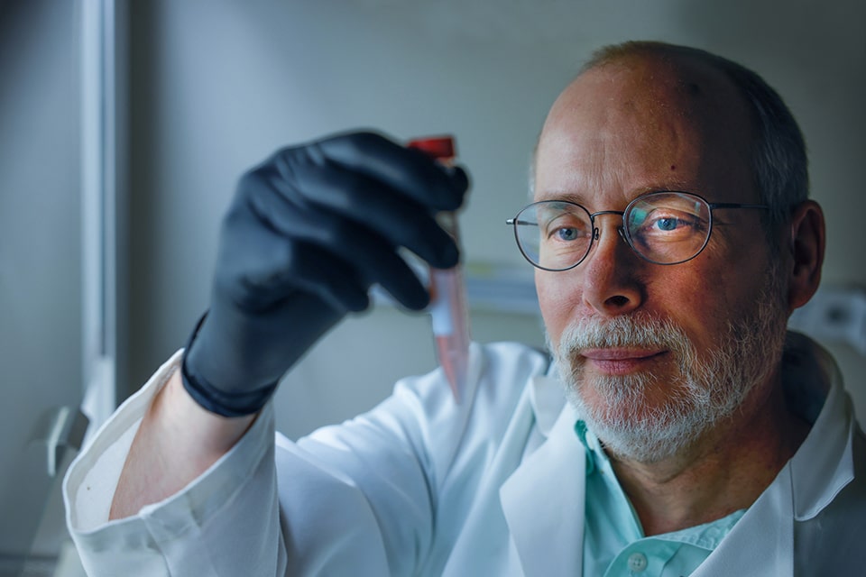 a man holding a test tube